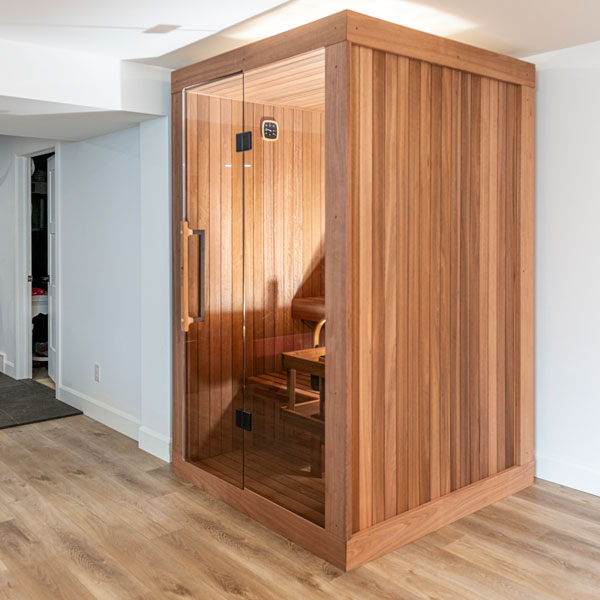 Dundalk CT Element Nook Indoor Sauna Kit. A stylish wooden indoor Sauna, 100% North American made. Pictured with its glass door closed.