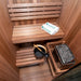 An inside view of the Dundalk CT Element Nook Indoor Sauna Kit. A stylish wooden indoor Sauna, 100% North American made. This image shows the tiered benches and electric heater.